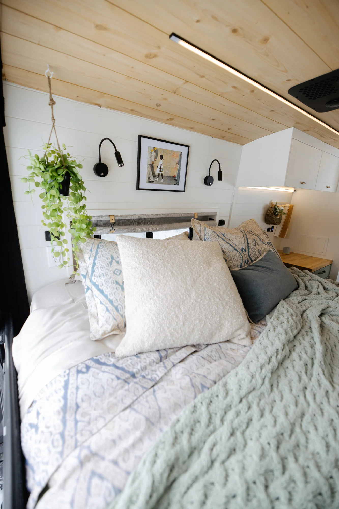 The Drifter 101 custom Ford Transit campervan built for Adrianne by Drifter Vans, Nomadik layout with knotty pine accents, soft green cabinetry, and a gold rain shower