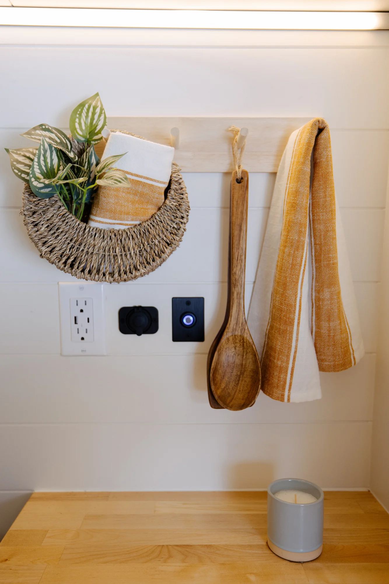 The Drifter 101 custom Ford Transit campervan built for Adrianne by Drifter Vans, Nomadik layout with knotty pine accents, soft green cabinetry, and a gold rain shower