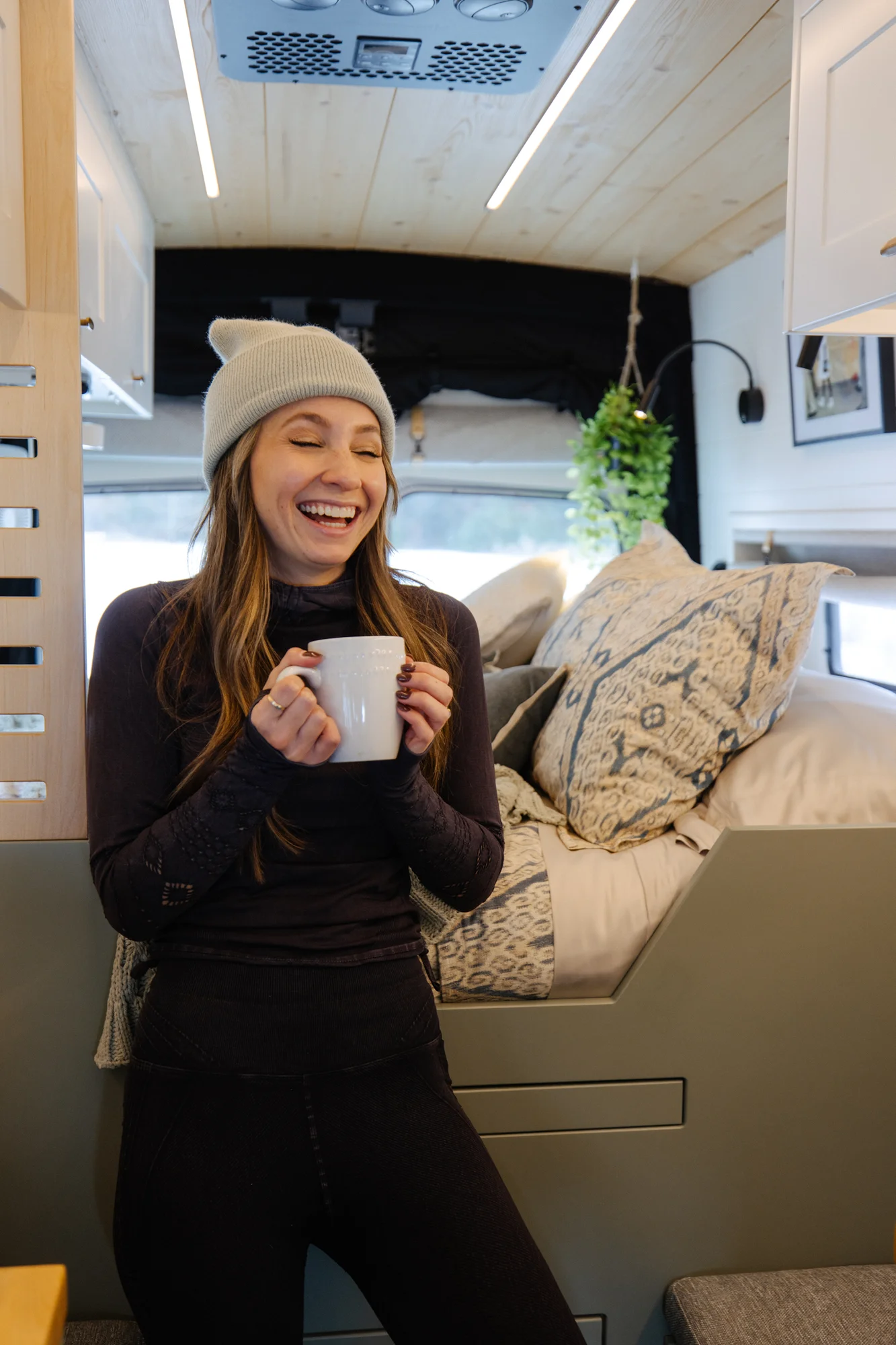The Drifter 101 custom Ford Transit campervan built for Adrianne by Drifter Vans, Nomadik layout with knotty pine accents, soft green cabinetry, and a gold rain shower