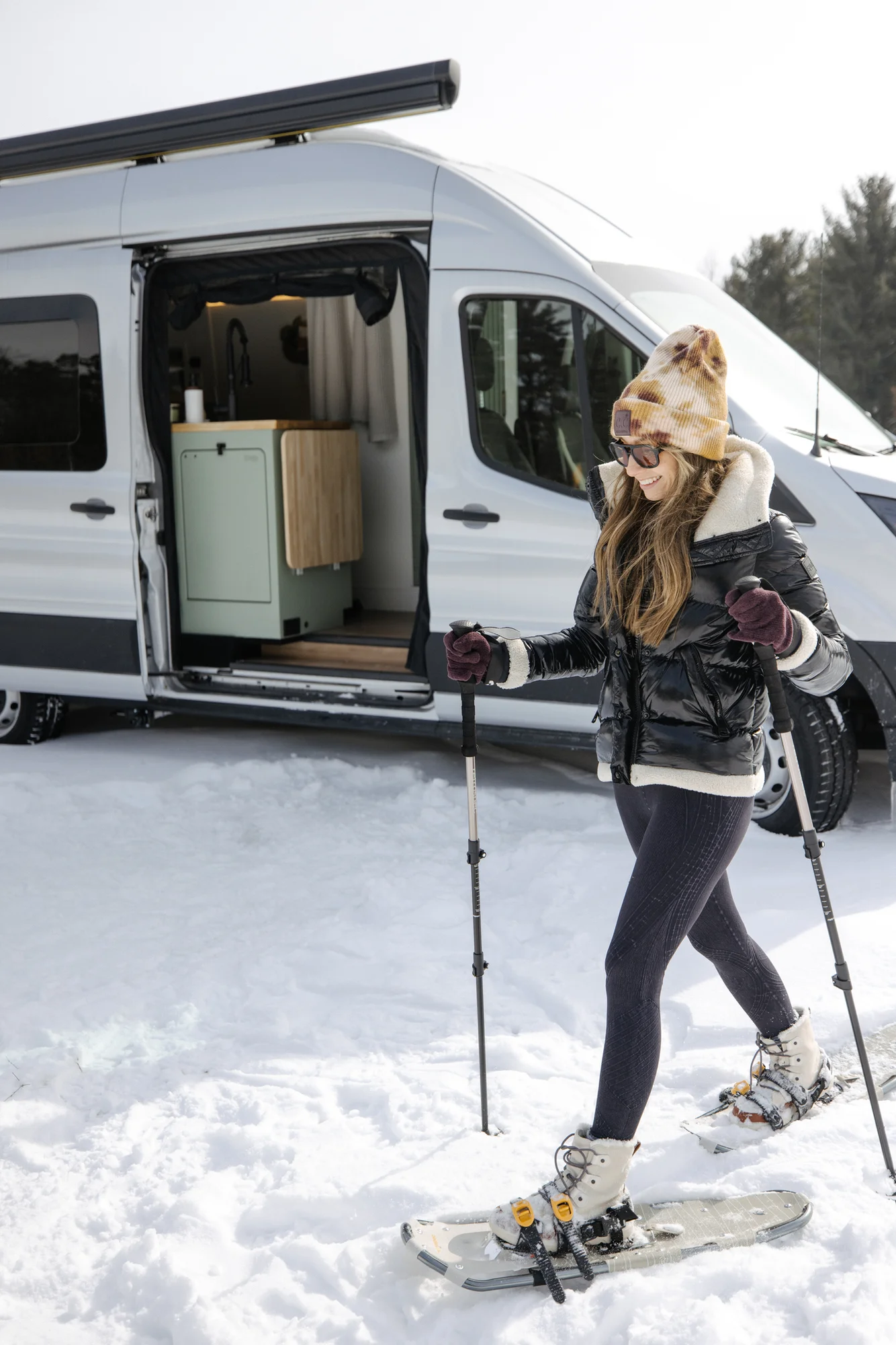 The Drifter 101 custom Ford Transit campervan built for Adrianne by Drifter Vans, Nomadik layout with knotty pine accents, soft green cabinetry, and a gold rain shower