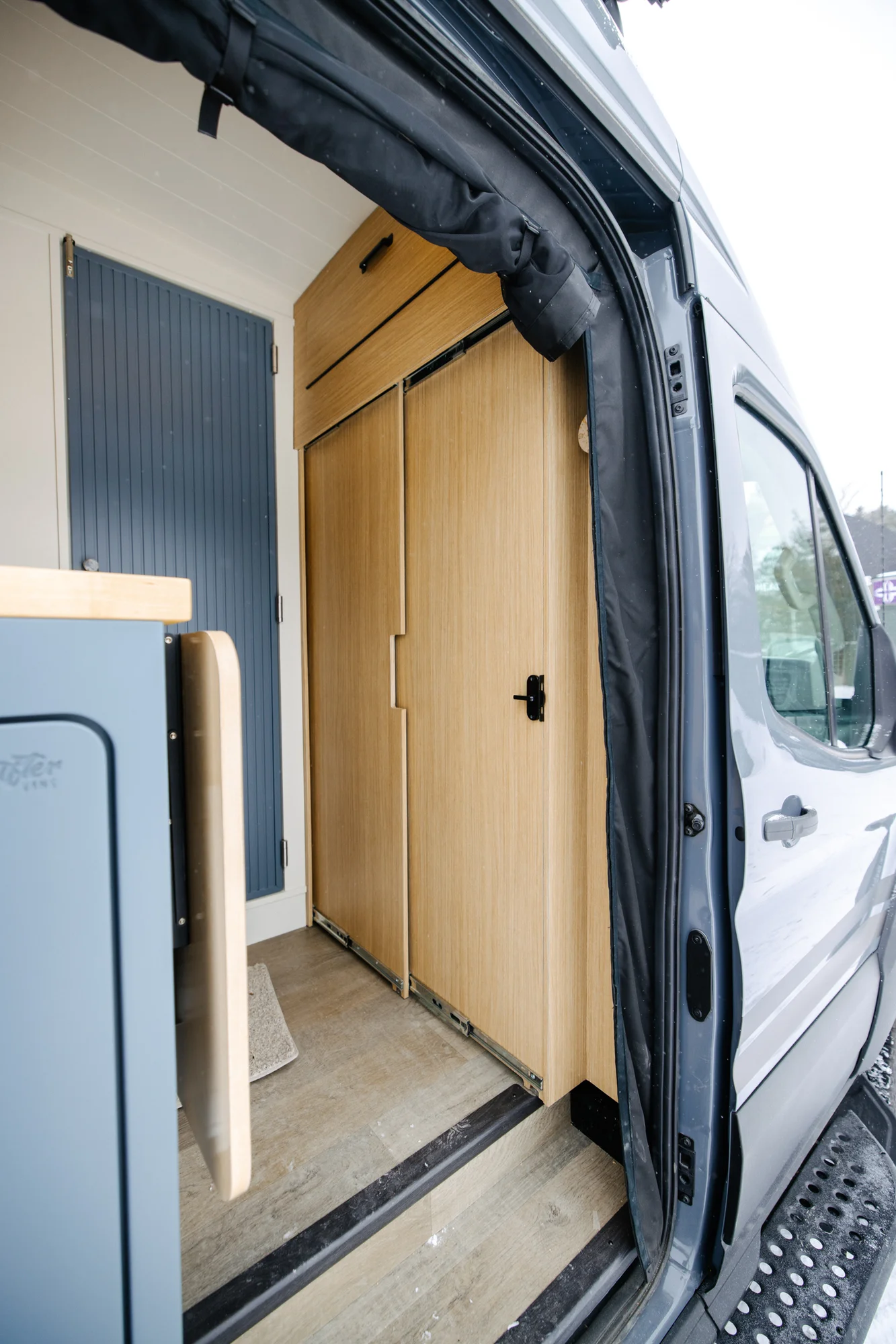 The Drifter 101 custom Ford Transit campervan built for Dan and Karen by Drifter Vans, Nomadik layout with an Indian autumn stone wet bath, trifold door, Aluminus bumper, and FVCO roof rack