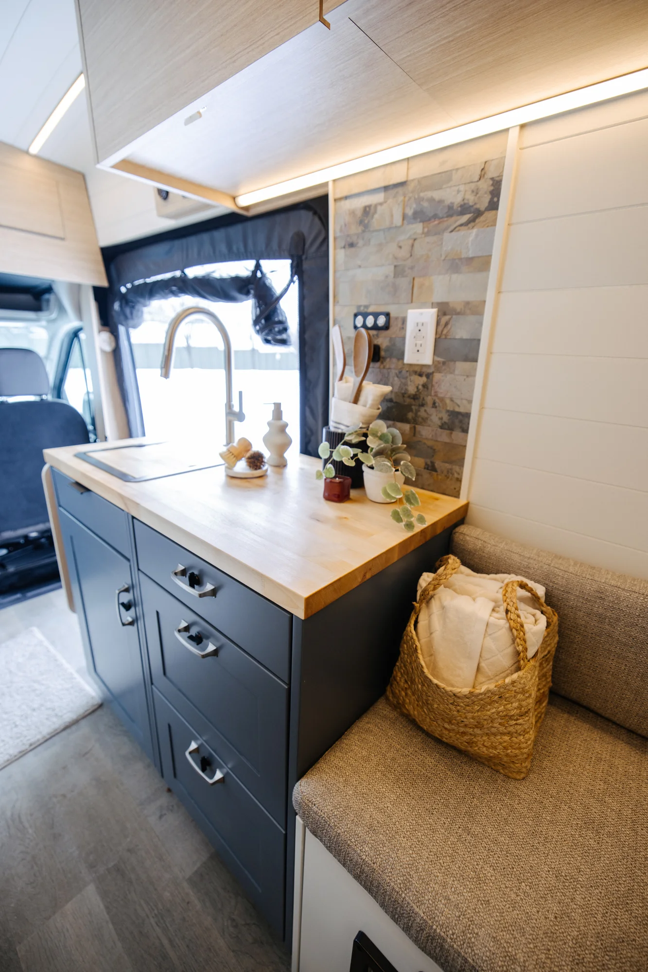 The Drifter 101 custom Ford Transit campervan built for Dan and Karen by Drifter Vans, Nomadik layout with an Indian autumn stone wet bath, trifold door, Aluminus bumper, and FVCO roof rack