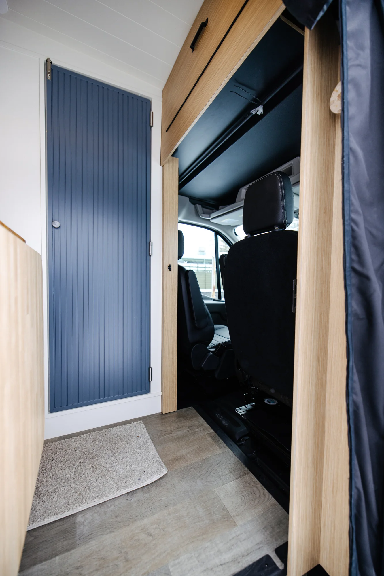 The Drifter 101 custom Ford Transit campervan built for Dan and Karen by Drifter Vans, Nomadik layout with an Indian autumn stone wet bath, trifold door, Aluminus bumper, and FVCO roof rack