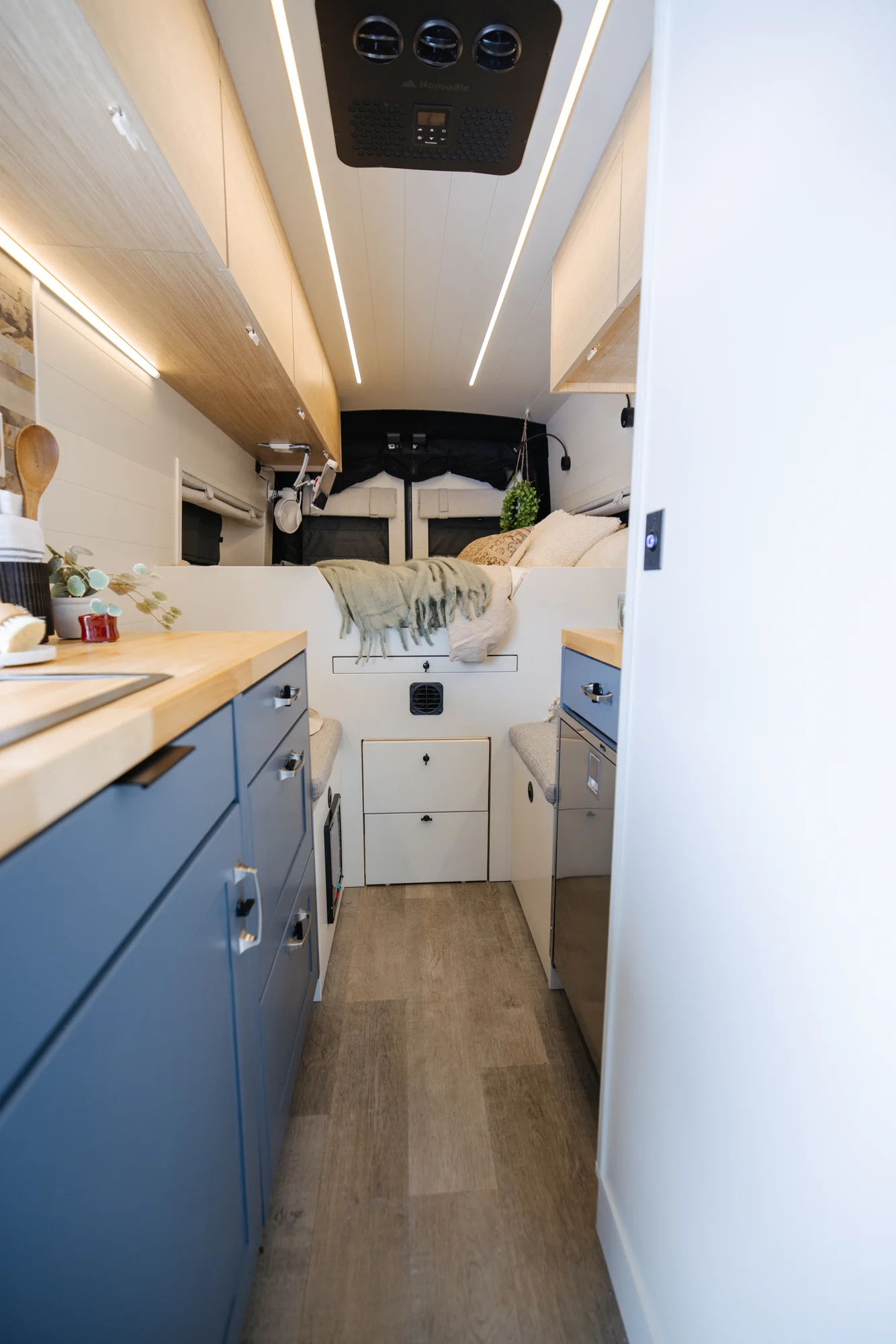 The Drifter 101 custom Ford Transit campervan built for Dan and Karen by Drifter Vans, Nomadik layout with an Indian autumn stone wet bath, trifold door, Aluminus bumper, and FVCO roof rack