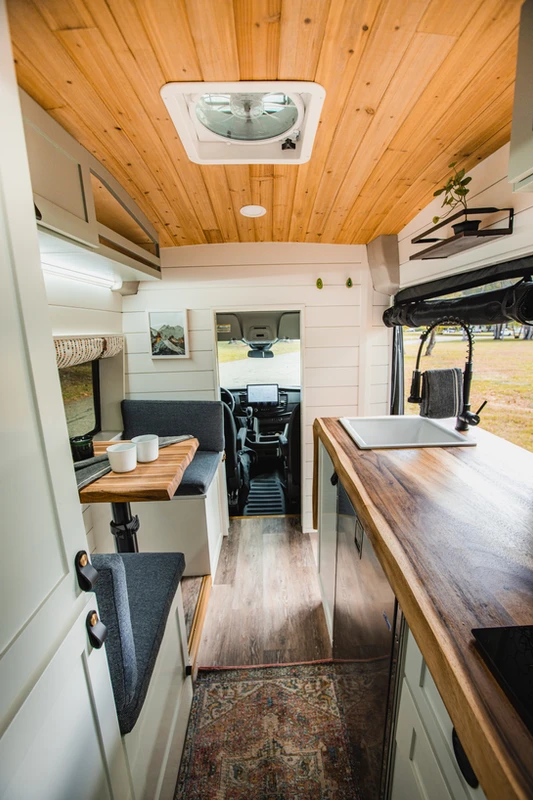 Custom Class B motorhome interior – Drifter Vans Wanderer layout with kitchen, seating, and storage designed for a travel nurse