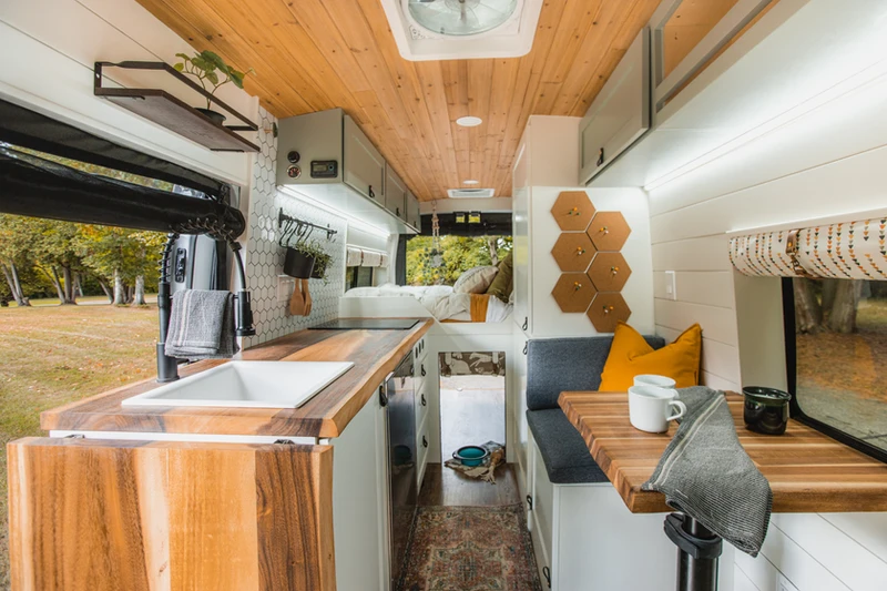 Drifter Vans coachbuilt interior – bright, modern Class B campervan living space where travel nurse Tess works and relaxes with her dog