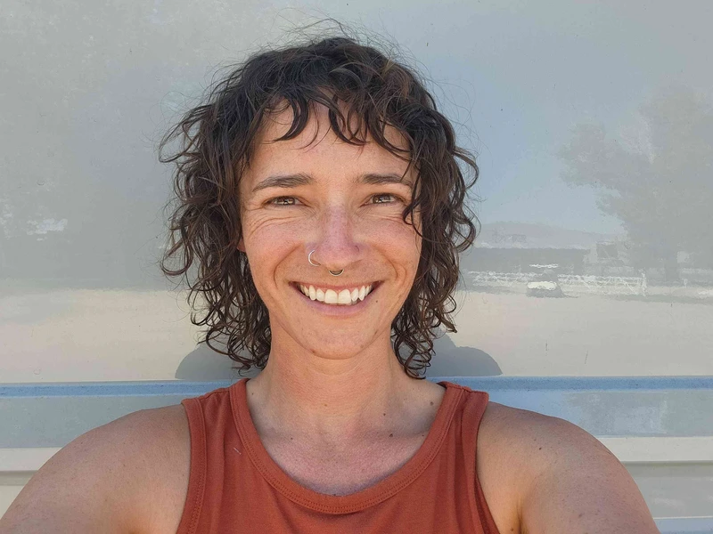 Travel nurse Tess – close-up headshot of a smiling van life nurse who lives in a custom Class B motorhome