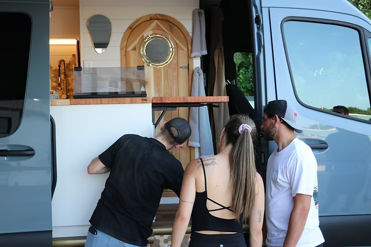 Drifter Vans employee demonstrating the adjustable flip counter to a client during their new custom van handoff