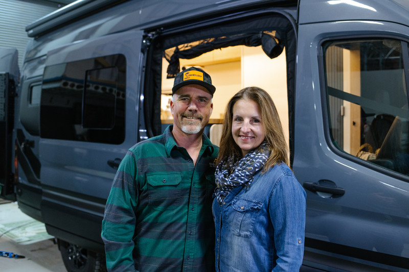 Couple taking picture in front of their new Drifter Van