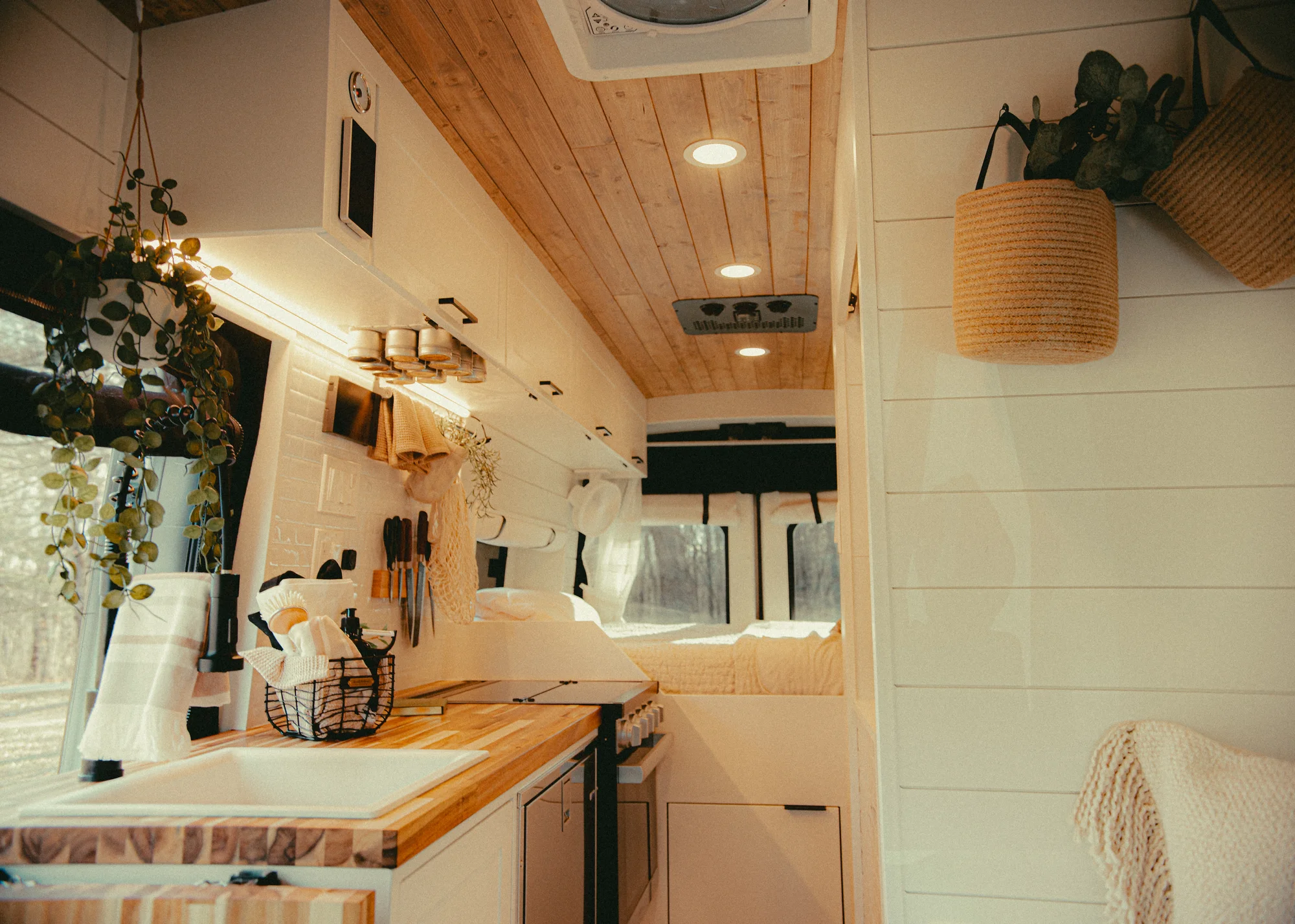 The Drifter 101 custom Ford Transit campervan built for Kyle and Zoe by Drifter Vans, Scout layout with white shiplap walls, light wood cabinetry, and a coastal-inspired interior