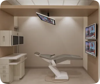Dental examination room with a reclining chair, overhead screen, and wall-mounted monitors.