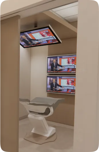 Modern room with three screens showing a news broadcast, and a white chair facing them.