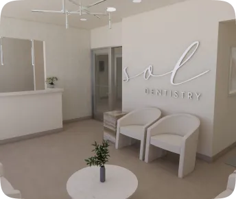Dental office waiting area with two white chairs and a small table. Sign reads "Sol Dentistry."
