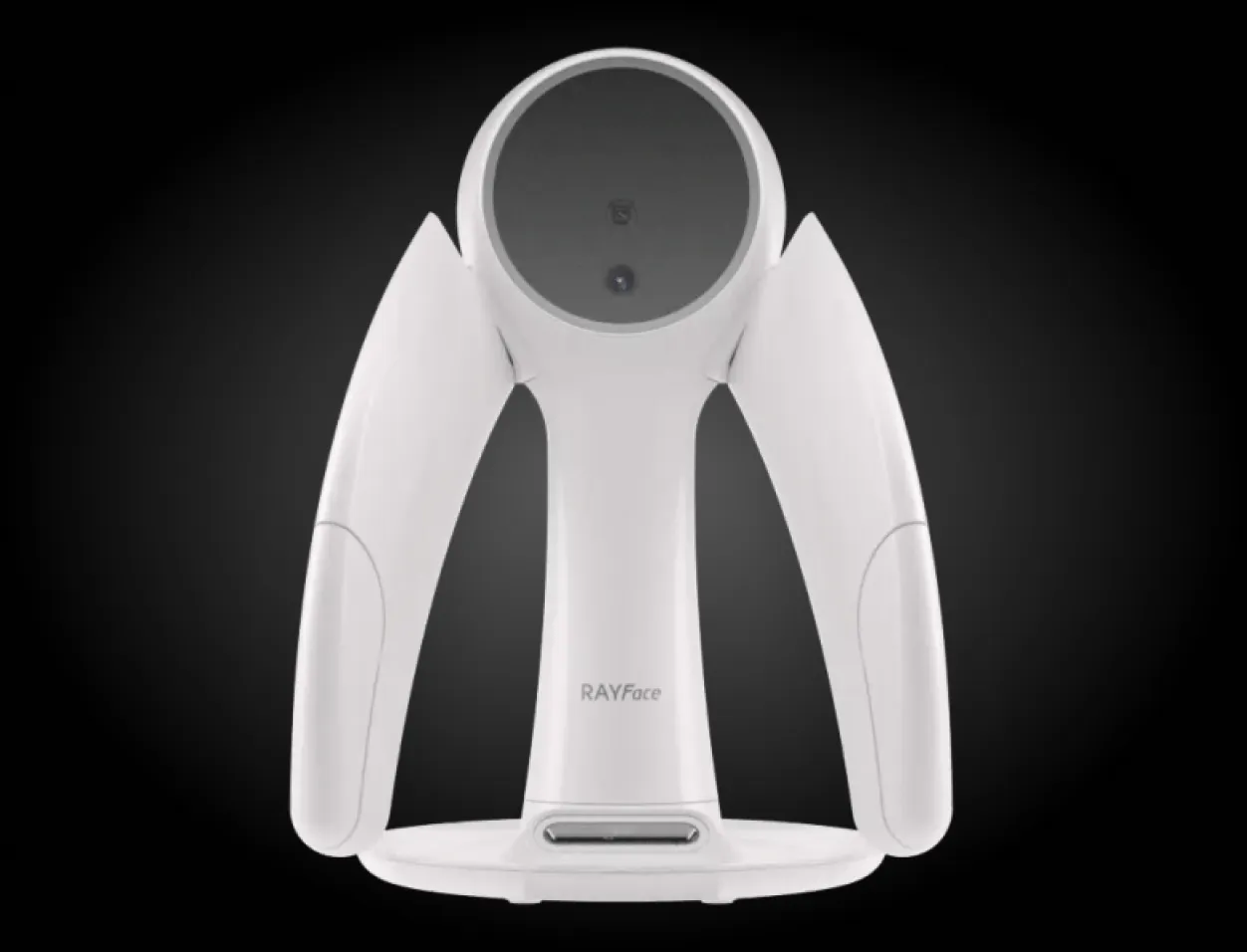 A white, futuristic device with a circular top and wing-like sides set against a dark background.