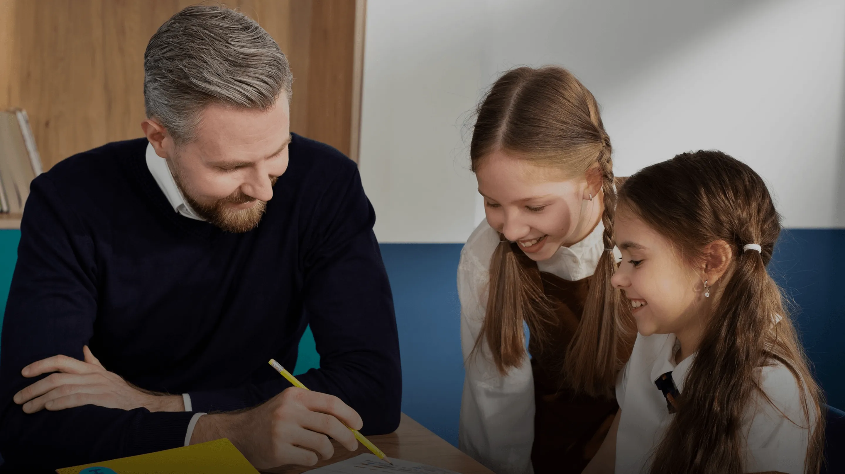 Professional reviewing documents with two children during a collaborative learning session.