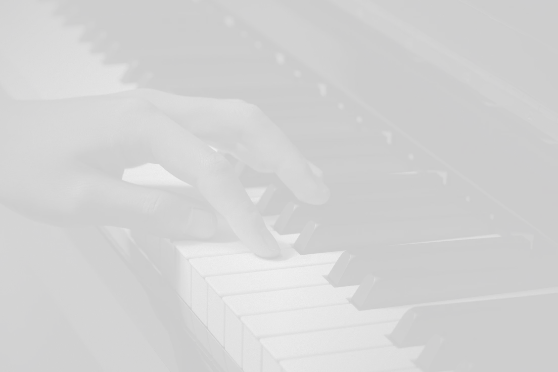Close-up of a hand playing white and black piano keys in black and white photo.
