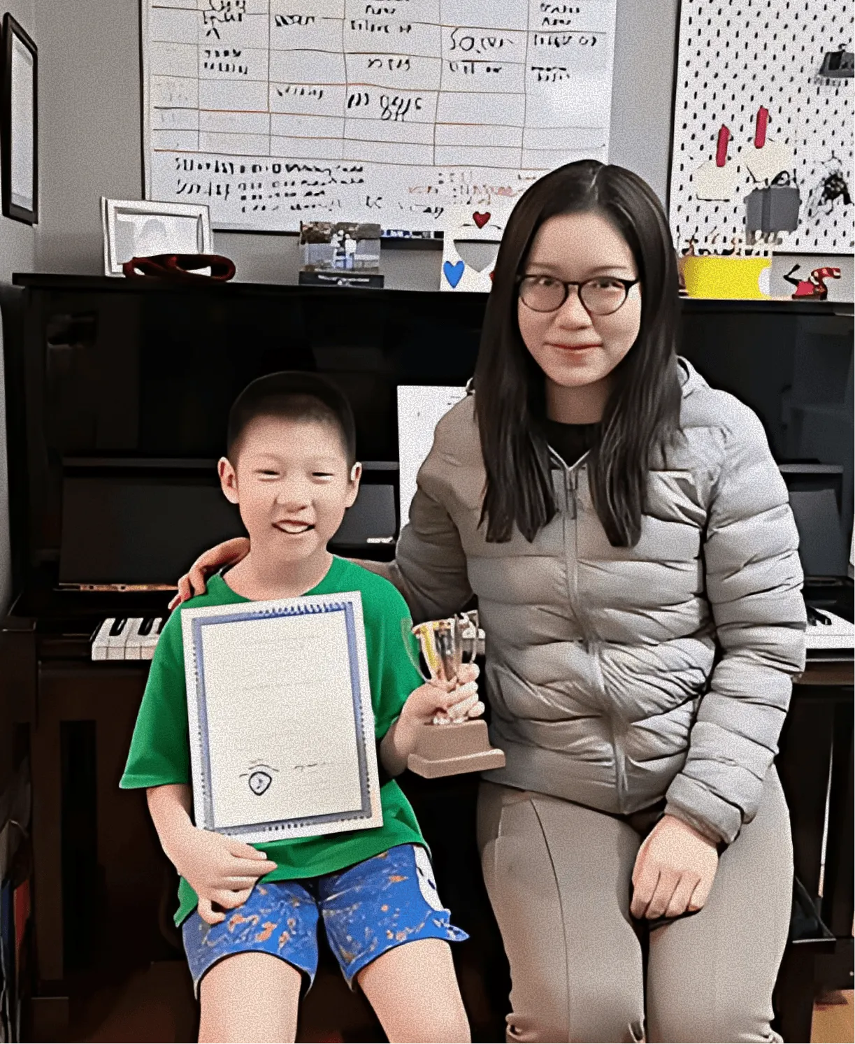 Piano teacher guiding a young student during a lesson