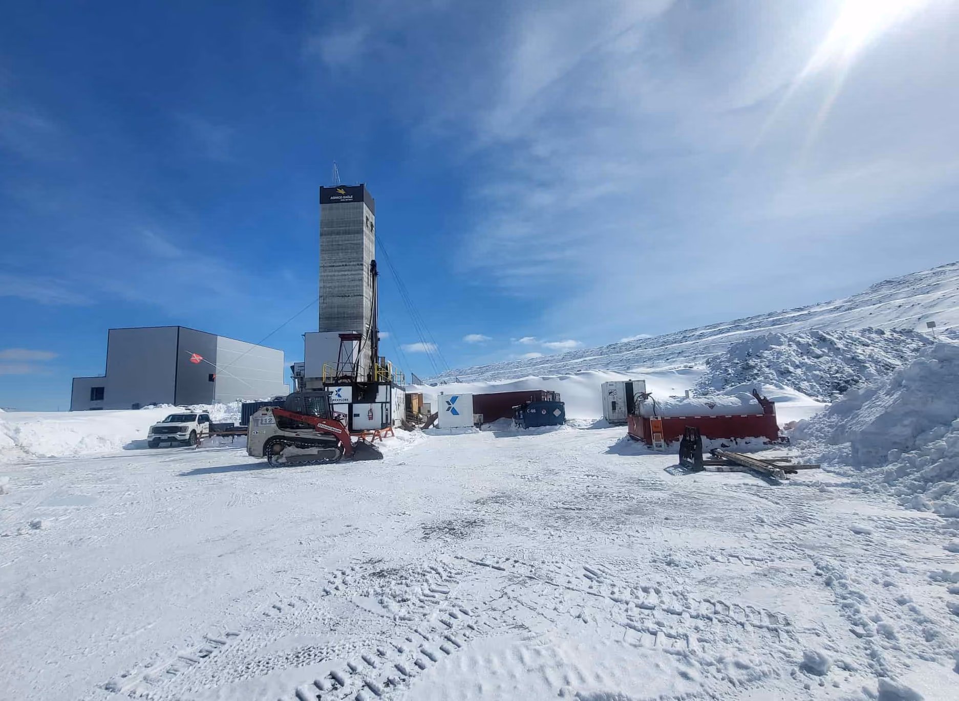 Corexplore drill rigs and support equipment at a snow-covered mountain project site
