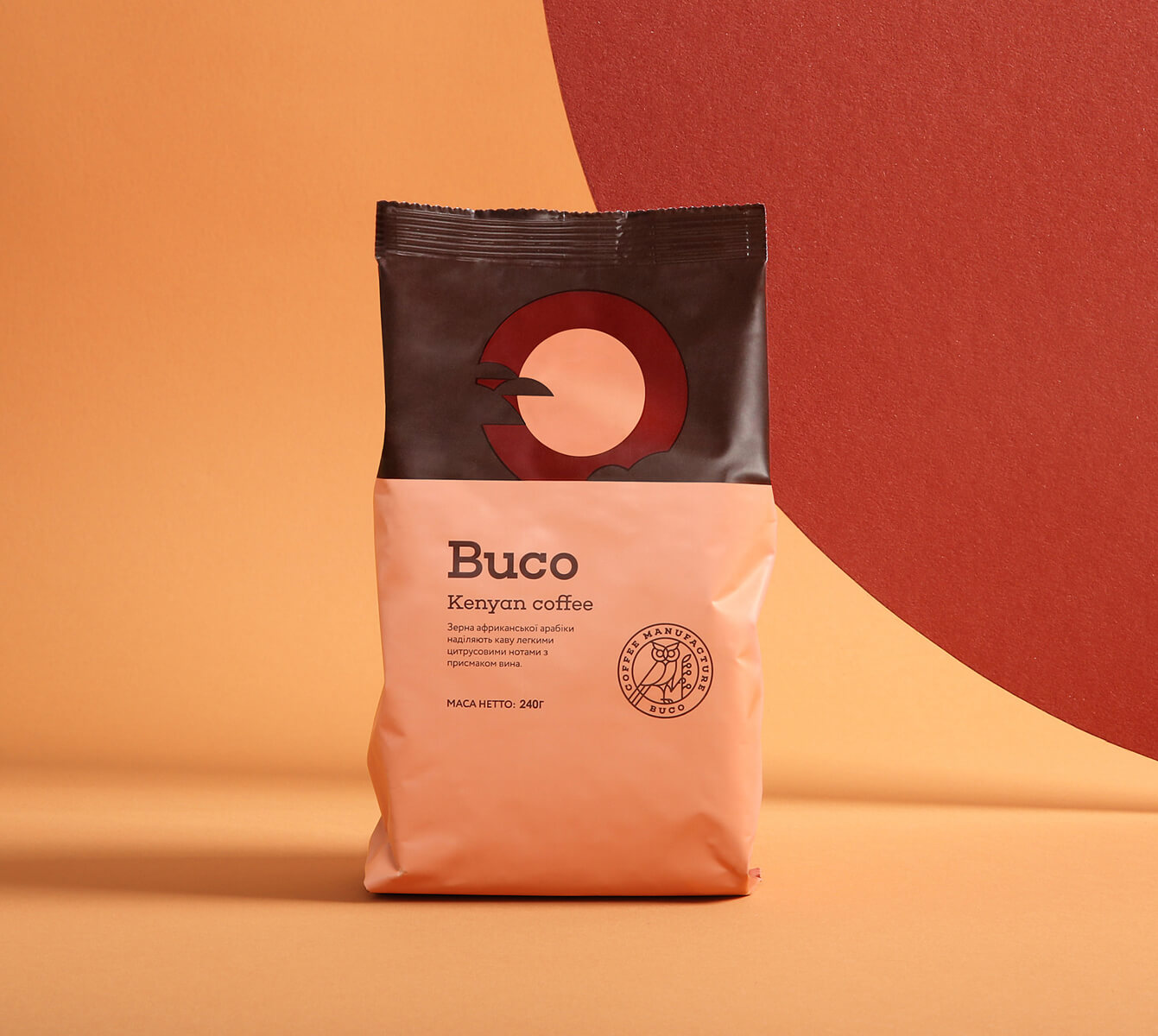 Package of Buco Kenyan coffee with a minimalist owl logo and text on peach and brown background.