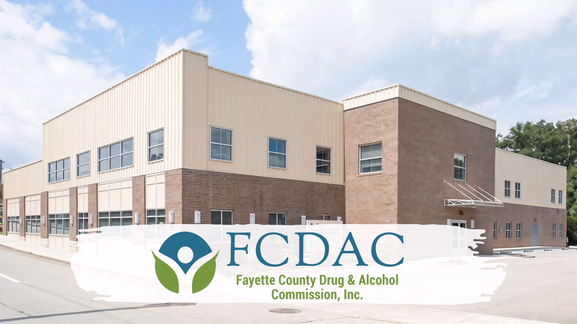 Exterior of a FCDAC building under a partly cloudy sky.