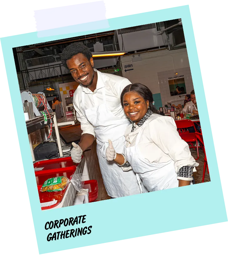 A man and woman are smiling for a photo in front of a buffet.