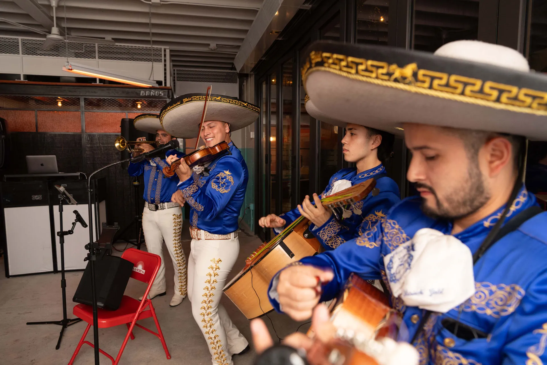 A man wearing a sombrero and playing a guitar.
