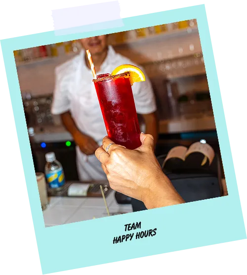 A man holding a drink in a restaurant.