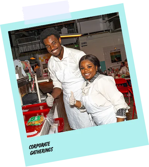 A man and woman are smiling for a photo in front of a buffet.