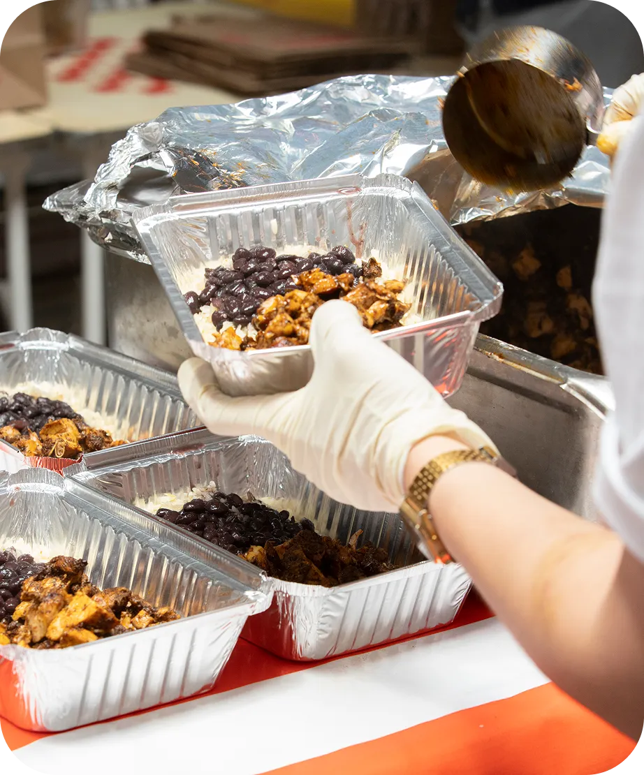 tacombi worker filling to-go container