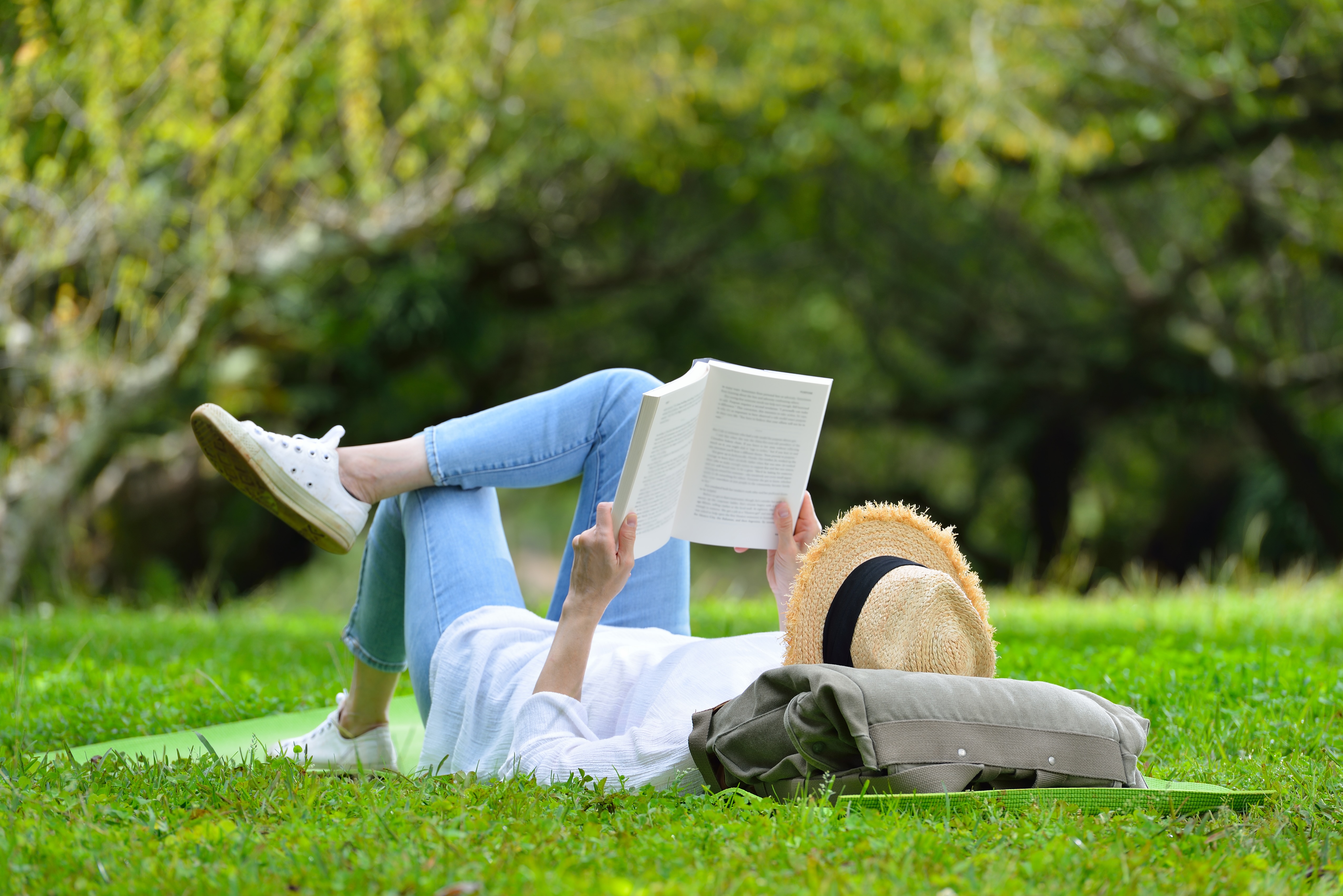 Woman laying in the park stock image