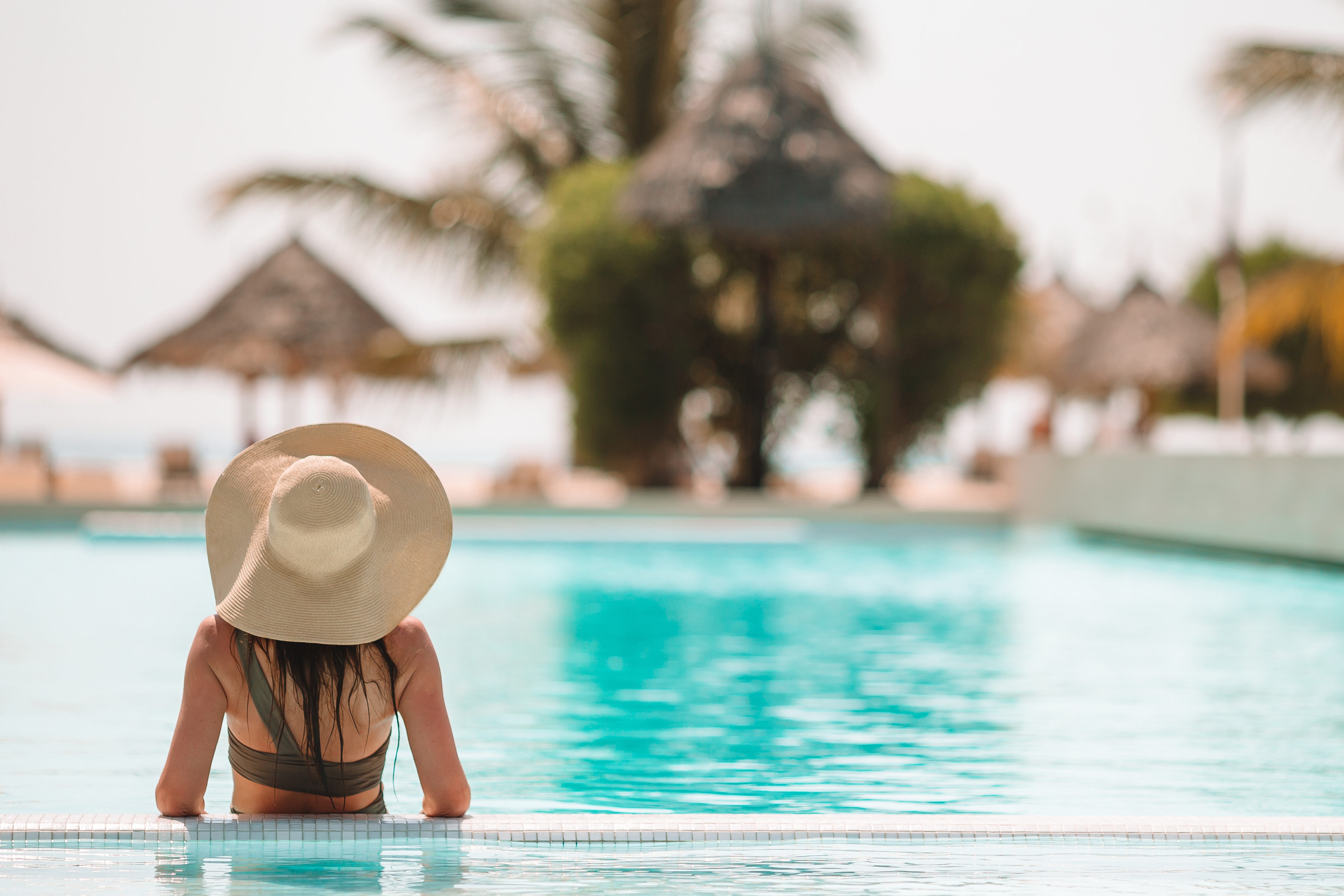 Woman relaxing by the pool stock image