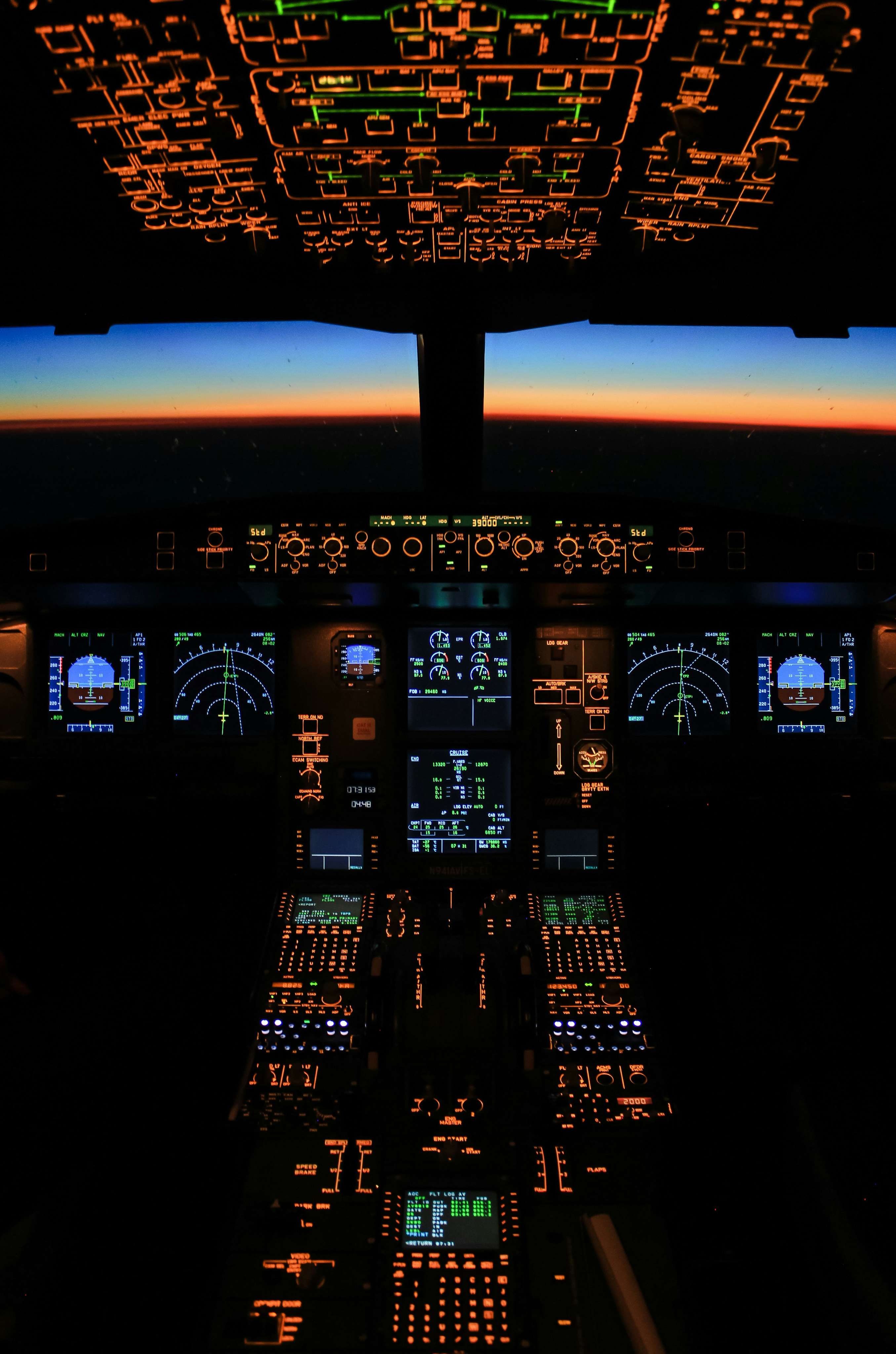 Illuminated cockpit instrument panel of a private jet at dusk
