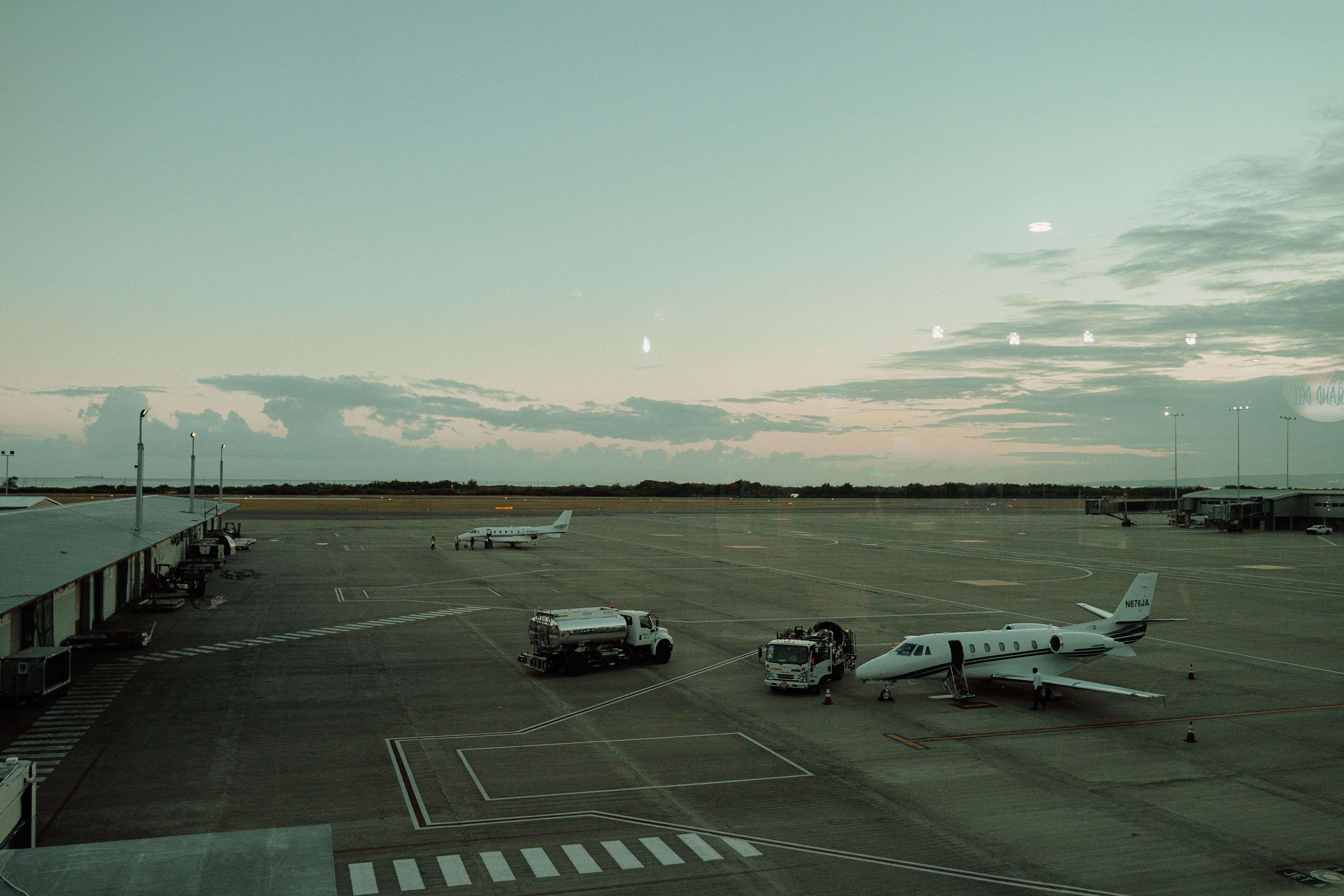 Private jet on the tarmac being serviced at dusk