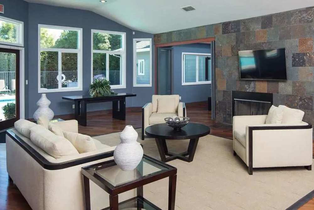 Clubhouse with sofas, tv, and view of swimming pool