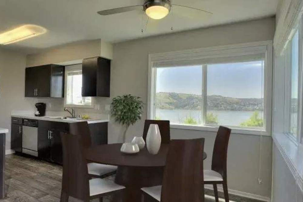 Dining area with table and large windows