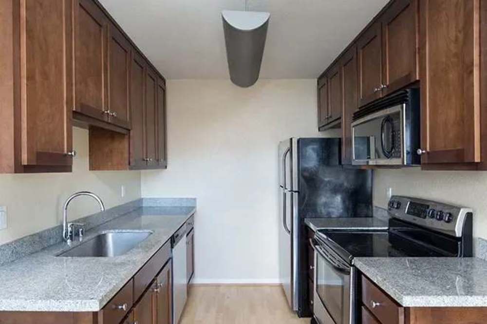 Kitchen with brown cabinets and stainless steel appliances