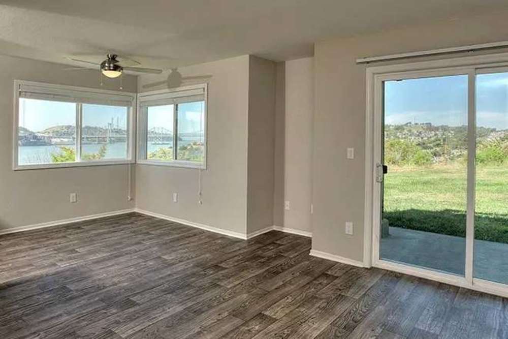 Unfurnished living area with sliding doors and large window