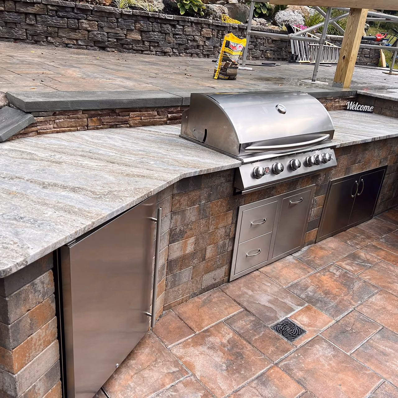 Beautiful custom outdoor living design with patios, walkways, and retaining walls by A and G Landscape Design and Excavation