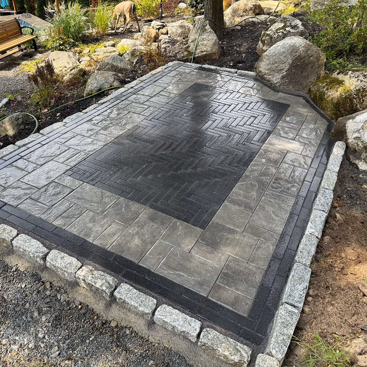 Custom natural stone patio installation by A and G Landscape Design and Excavation in New York