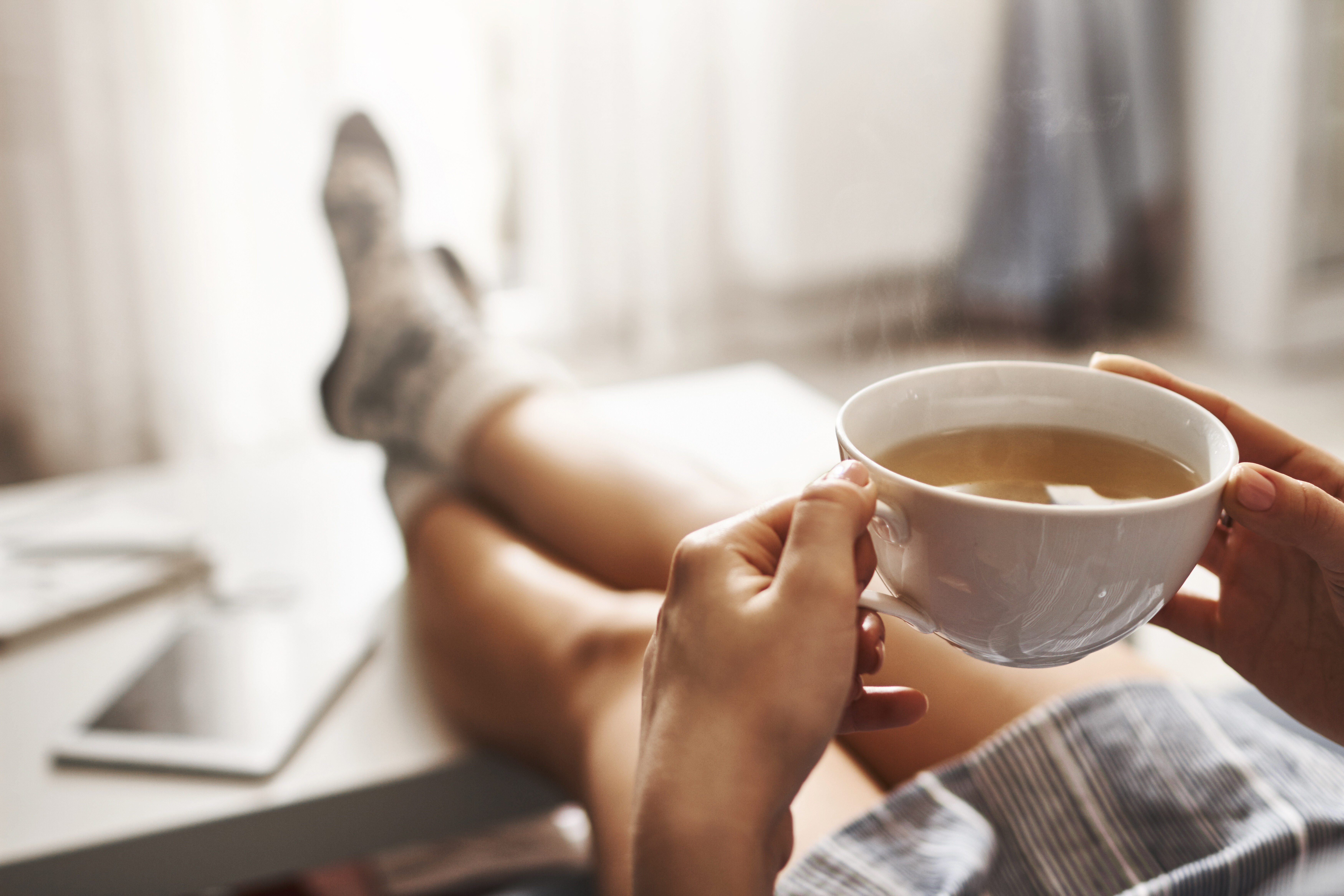 Person sitting holding coffee stock image