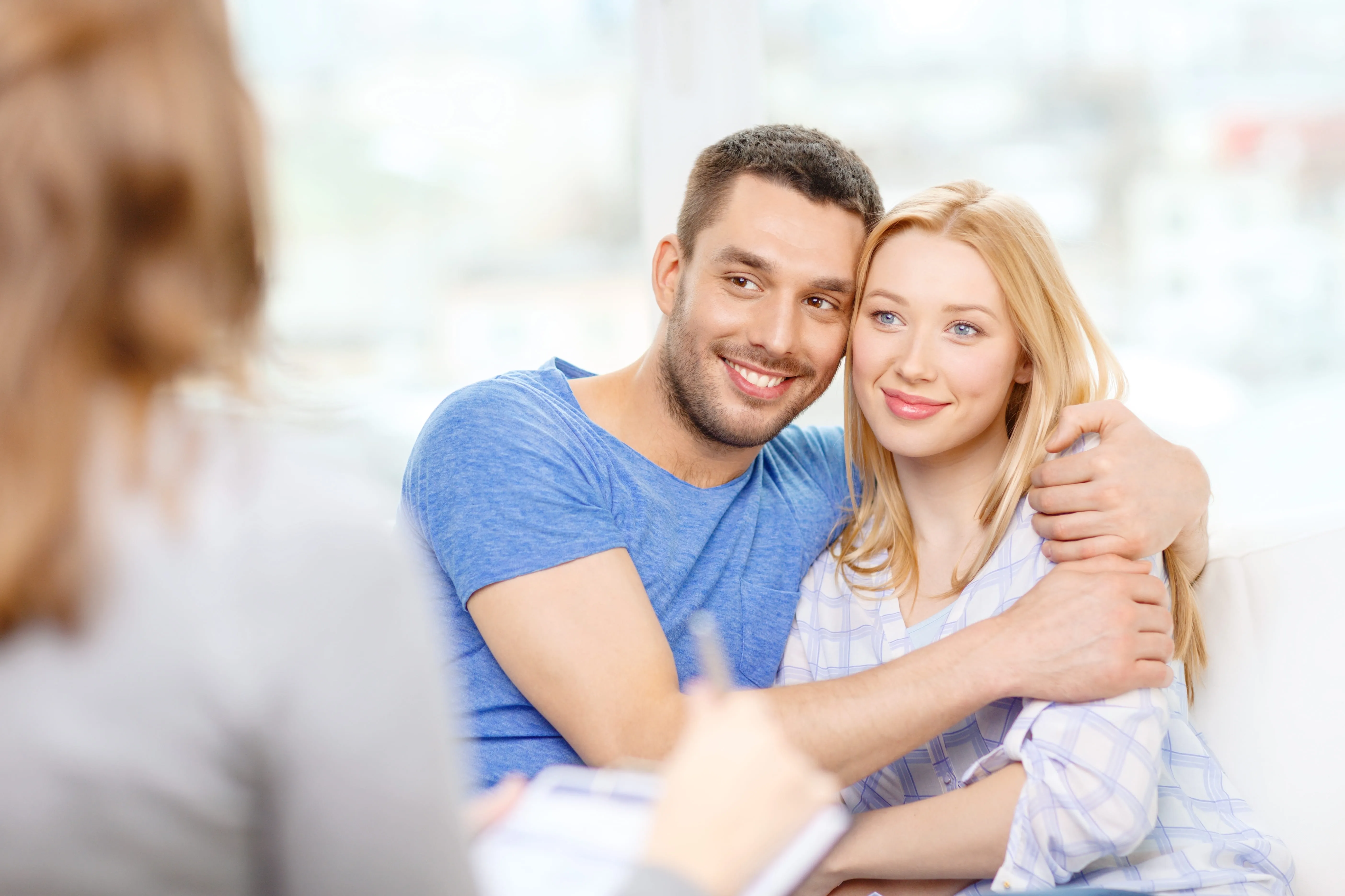 Couple embracing during a therapy session.