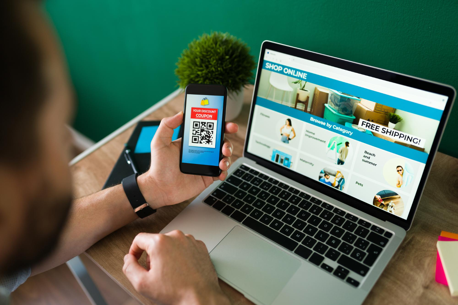 Shopper scanning a QR code beside an ecommerce store on a laptop