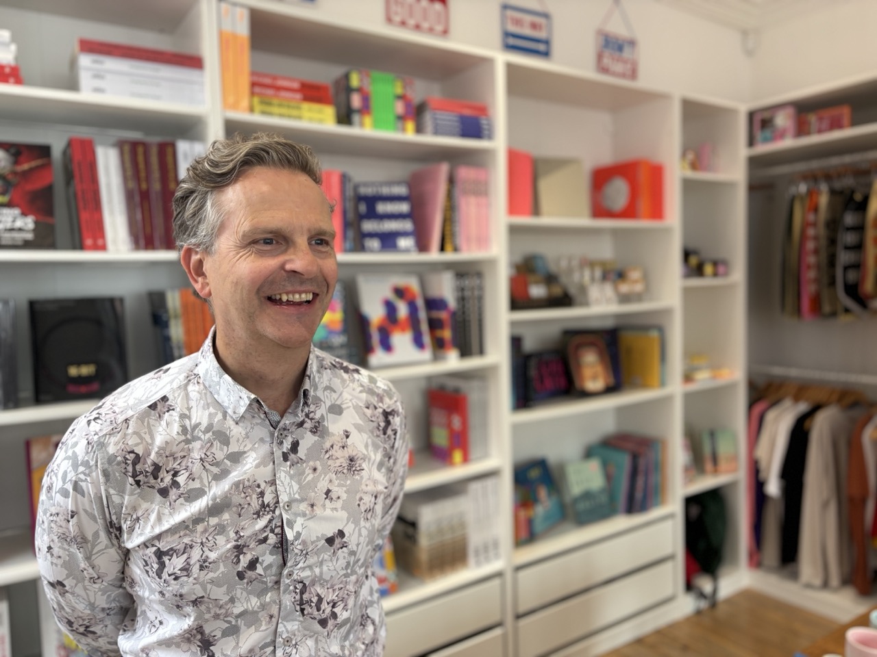 Anthony Tattum, fractional CMO, smiling in front of a bookshelf