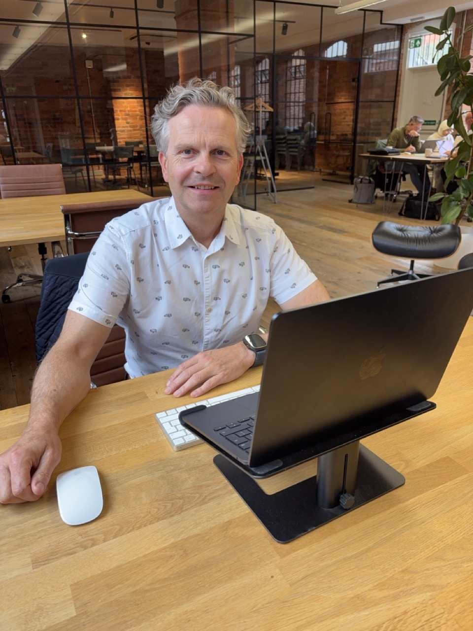 Anthony Tattum at his desk with a laptop