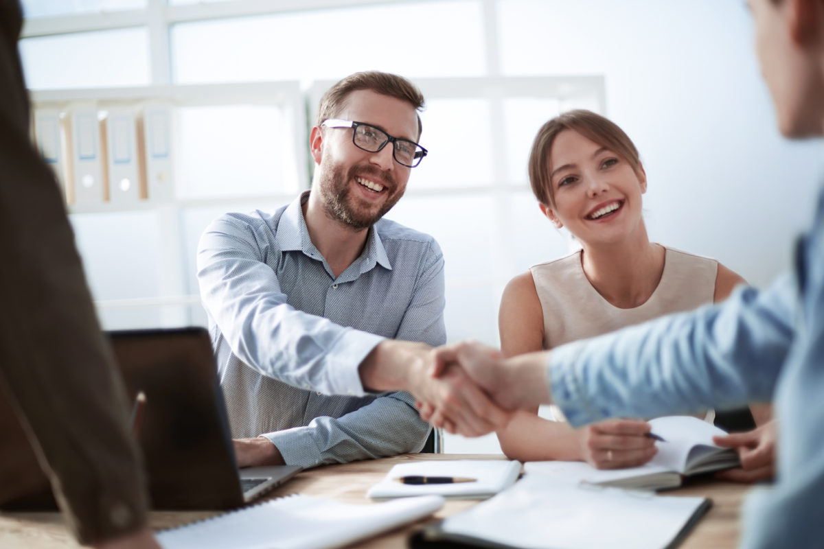 Image of two people shaking hands to represent commercial lease negotiation