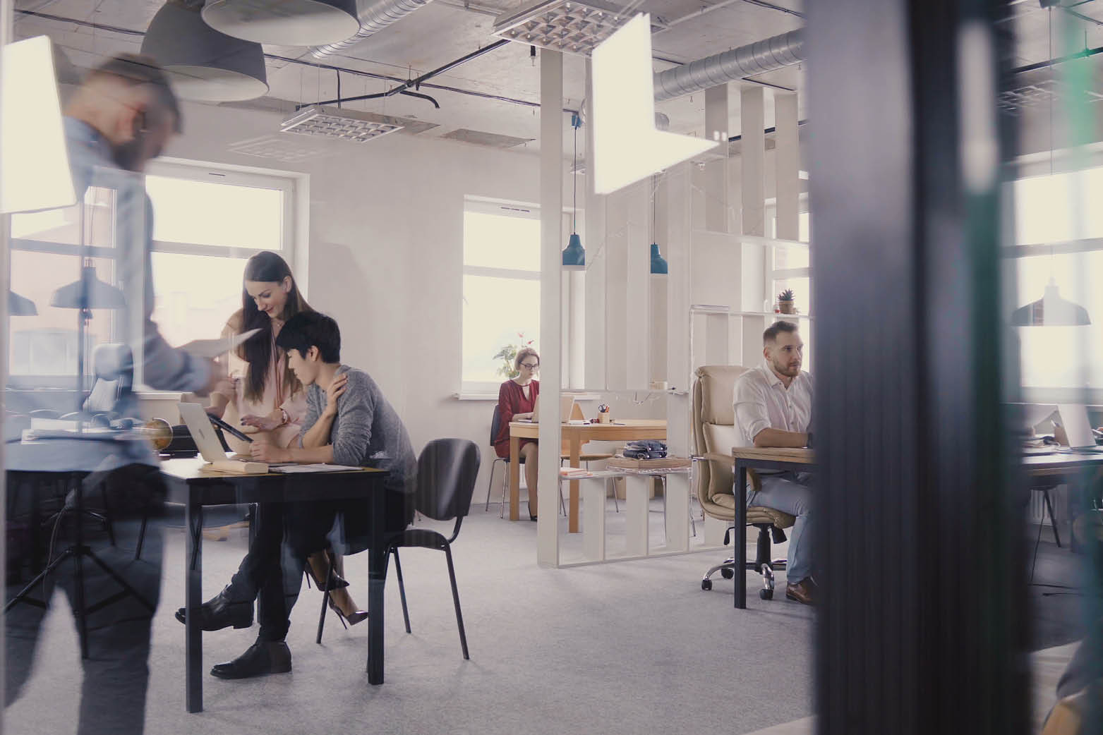 Office workers working on floor representing commercial subleasing agreement