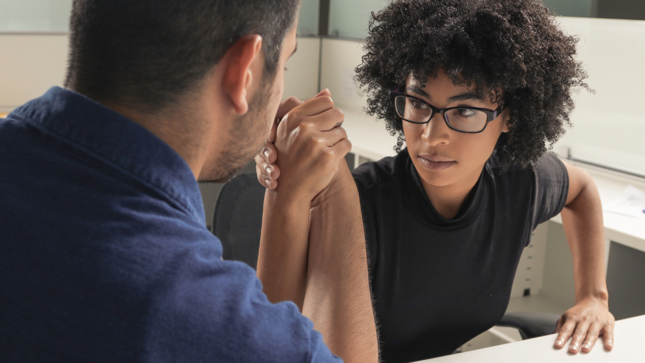 two people having an arm wrestle illustrating competition at the lease negotiation table