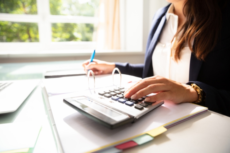 Female commercial tenant looking at base year outgoings calculations