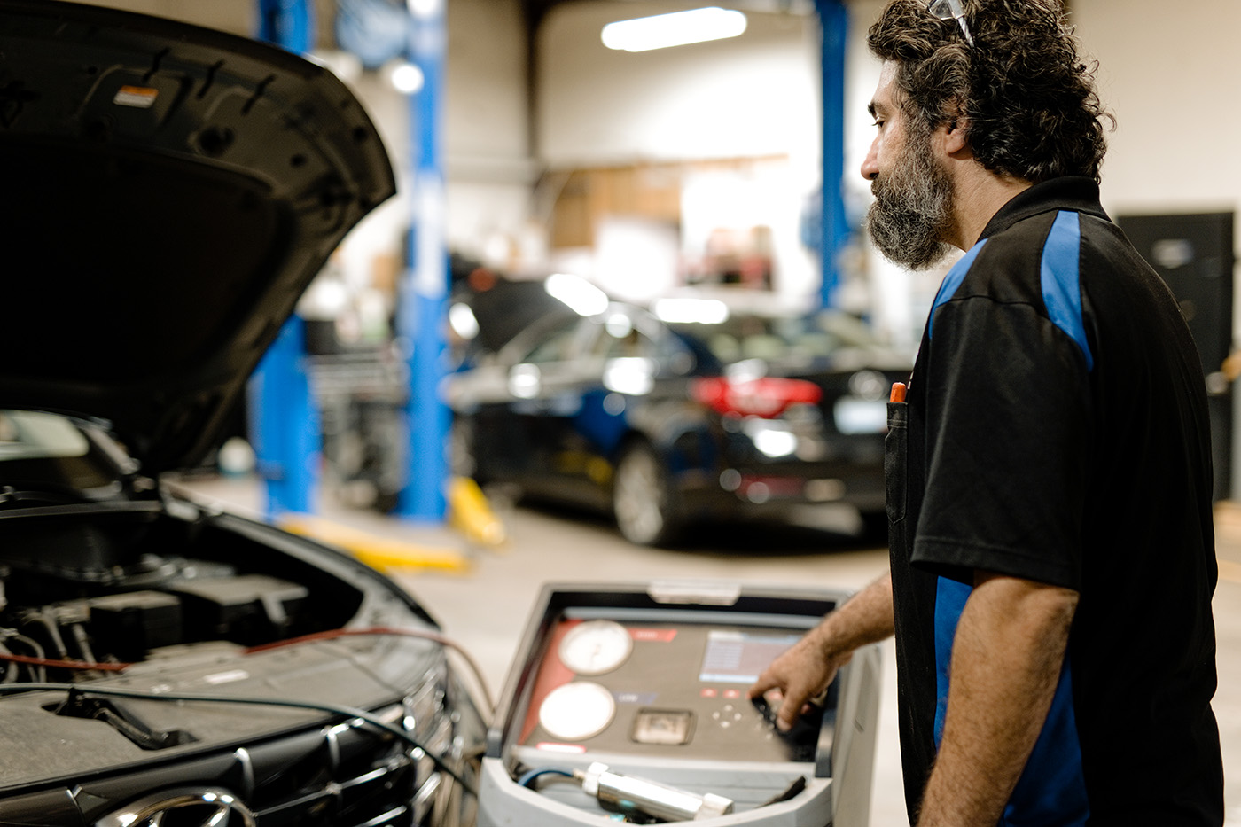 ASE-certified technician performing professional heating and air conditioning repair and diagnostics at Primary Care Auto Repair in Warwick, Rhode Island.