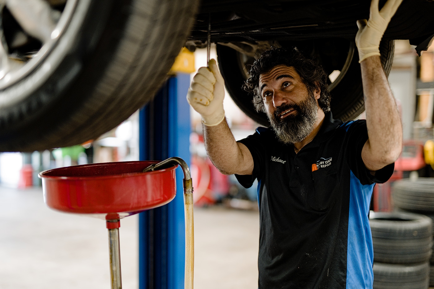 ASE-certified technician performing a professional oil change and preventive maintenance service at Primary Care Auto Repair.